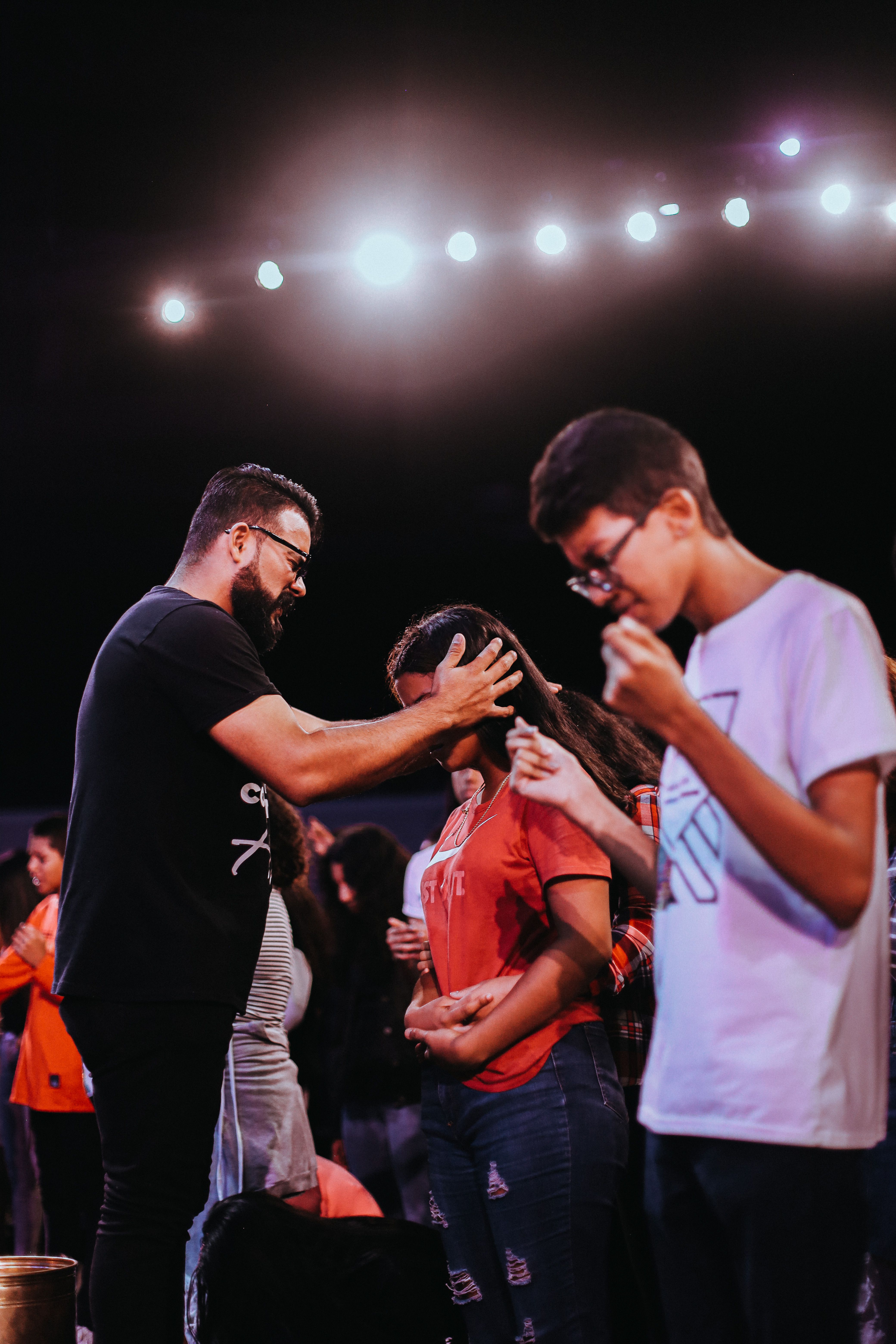 Young people sharing a candid moment of prayer
